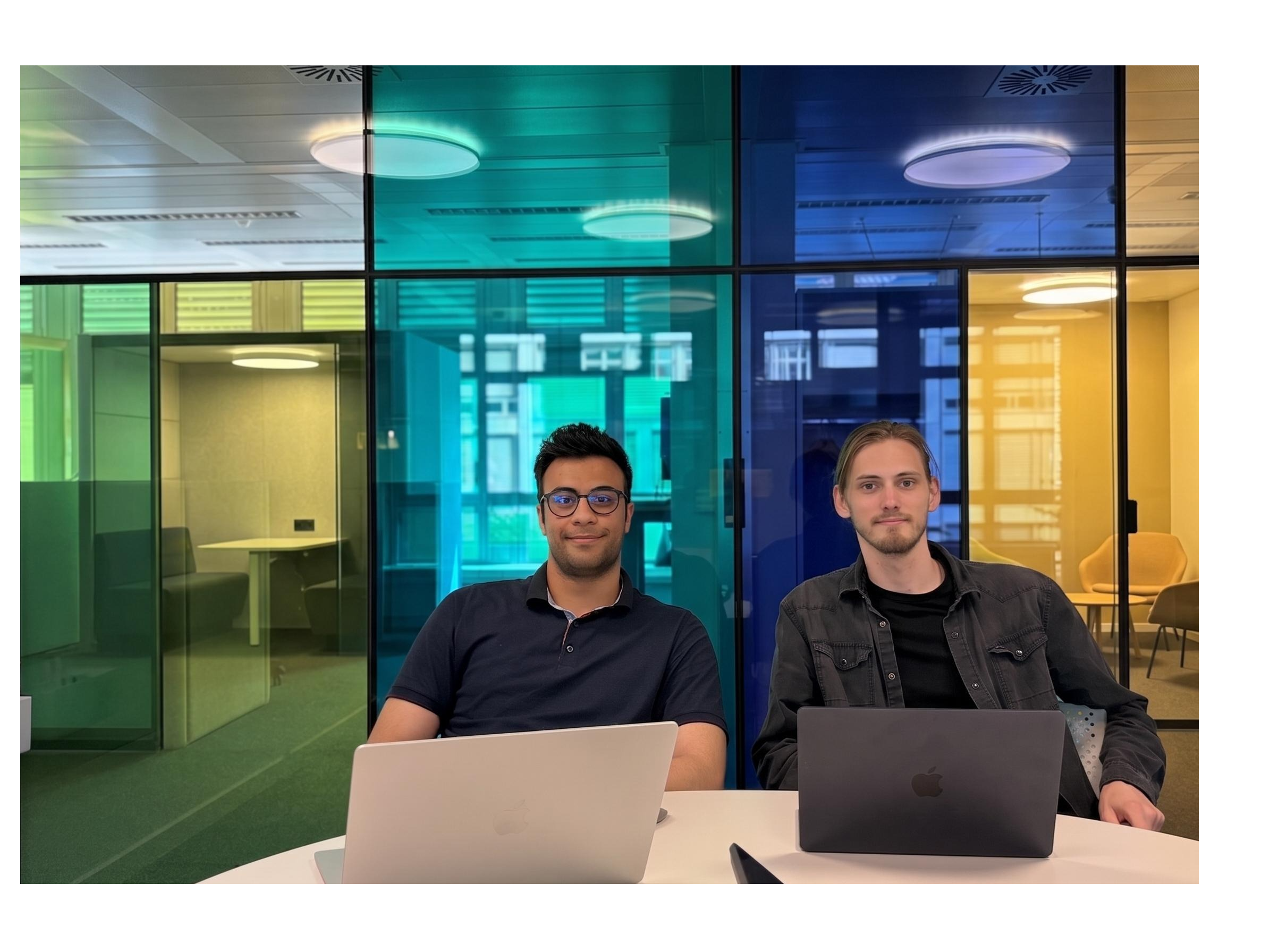 two professional tech entrepreneurs standing in a modern minimalist office with glass walls, soft cinematic lighting, looking focused